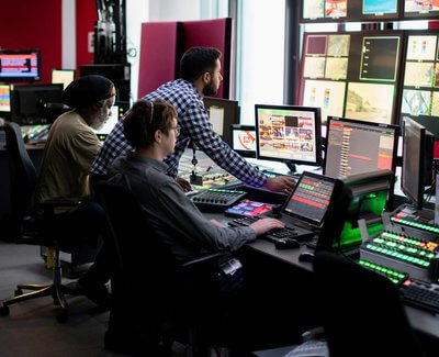 People looking at computer screens on monitoring secreens